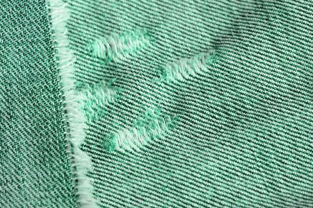 Old jeans texture close up. Green denim backgroundの写真素材