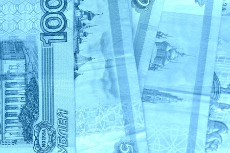 Banknote background from Russian rubles close up. Blue color toned