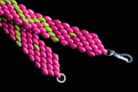 Beaded bracelet bright pink color on a dark background close upの写真素材
