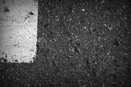 Old dirty asphalt texture with white paint on it. Top viewの写真素材