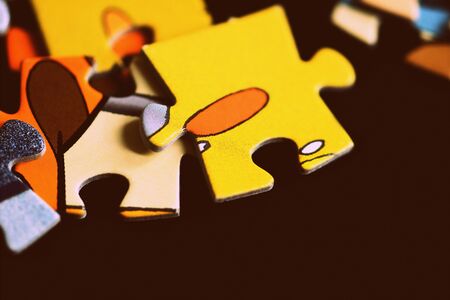 Children's puzzles on a dark background close up. Retro style toned