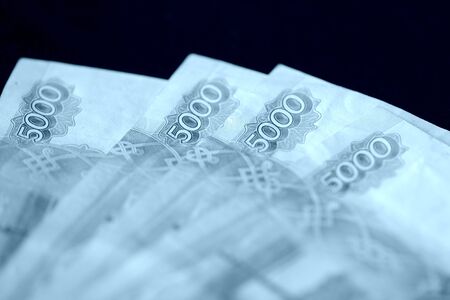 Russian banknotes of five thousand rubles close-up. Money background blue color toned