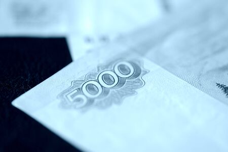 Russian banknotes of five thousand rubles close-up. Money background blue color toned