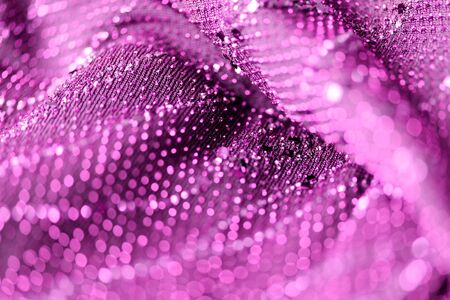 Purple color textile with sparkles close up. Fabric backgroundの写真素材