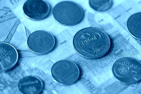Obsolete Belarusian banknotes and coins close-up, blue color toned
