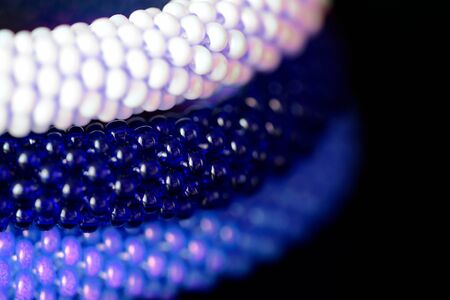 Three beaded bracelets on a dark background close upの写真素材