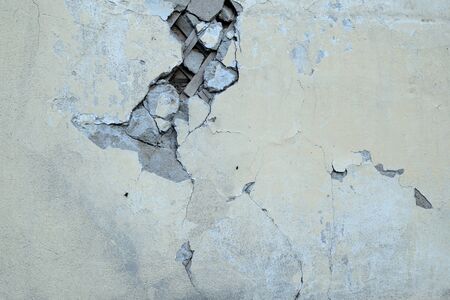 Fragment of an old cracked wall closeup of an abandoned house. Abstract backgroundの写真素材
