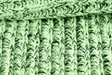 Knitted woolen texture close up. Textile background green color tonedの写真素材