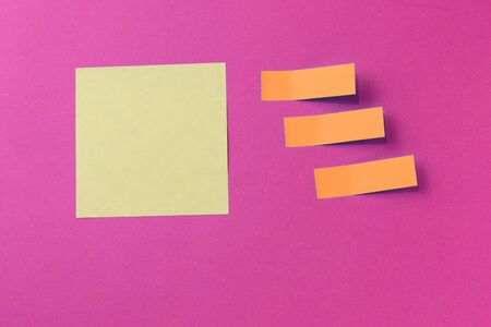 Sticker notes on a bright pink background. Top view, copy space. Business concept, horizontal...