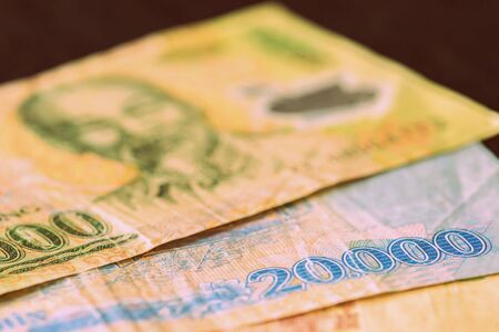 Vietnamese dong closeup on a dark background. Money background retro style tonedの写真素材