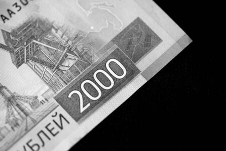 Two thousand rubles russian banknote on a dark background close up. Money background black and white