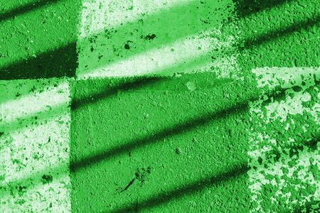 Asphalt surface with white paint and shadow. Abstract background green color tonedの写真素材