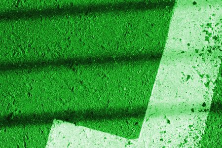 Asphalt surface with white paint and shadow. Abstract background green color tonedの写真素材