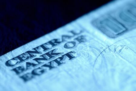 Ten egyptian pounds bill on a dark background close-up. Money background blue color tonedの写真素材