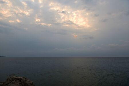 Overcast sky over the sea on a summer evening near the coast of Sicily. Natural backgroundの写真素材