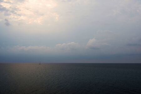Overcast sky over the sea on a summer evening near the coast of Sicily. Natural backgroundの写真素材