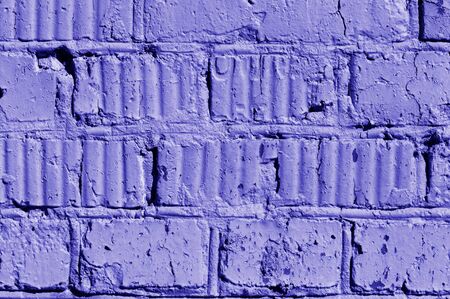 Old painted brick wall close-up. Brick wall background blue color toned