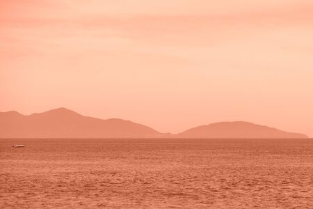 Beautiful seascape in the morning. Hoi An, Vietnam. Orange color tonedの写真素材