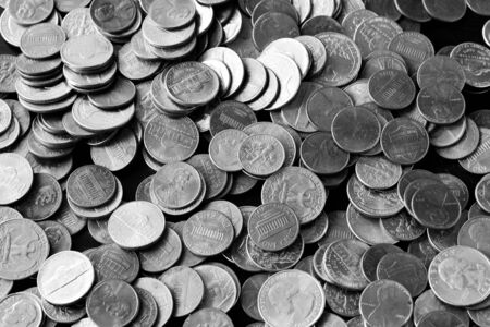 American cents on an old black wooden surface close-up. Monochrome money backgroundの写真素材