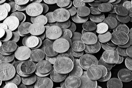 American cents on an old black wooden surface close-up. Monochrome money backgroundの写真素材