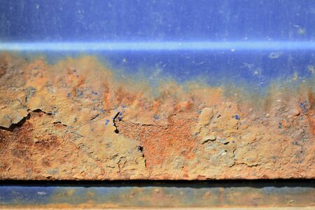 Fragment of an old rusted blue car close-up. Abstract backgroundの写真素材