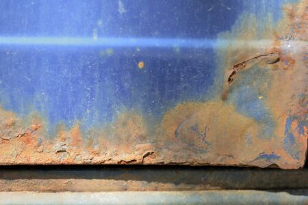 Fragment of an old rusted blue car close-up. Abstract backgroundの写真素材