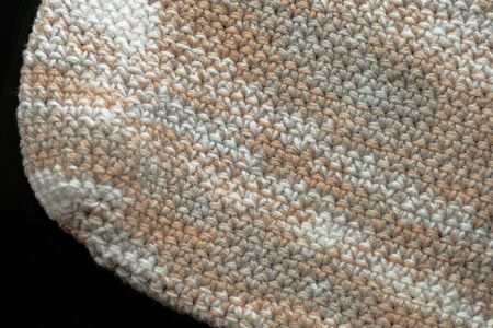 Fragment of crocheted canvas of melange yarn closeup. Abstract background