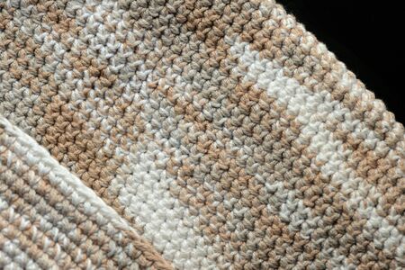 Fragment of crocheted canvas of melange yarn closeup. Abstract backgroundの写真素材