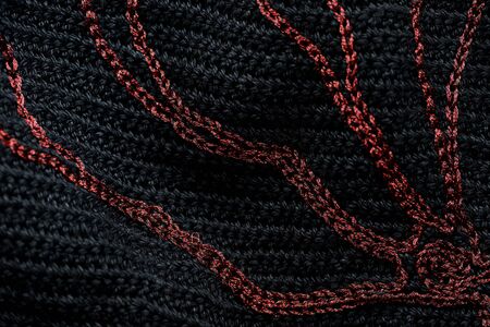 Close-up of a black crocheted bag with embroidery red thread. Hand made concept. Top viewの写真素材