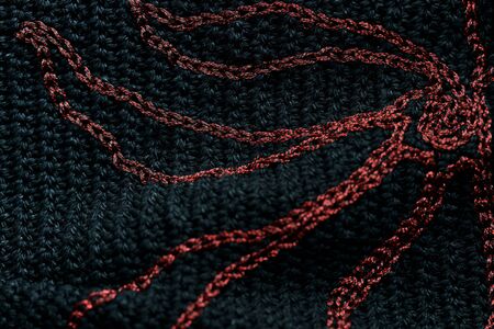 Close-up of a black crocheted bag with embroidery red thread. Hand made concept. Top viewの写真素材