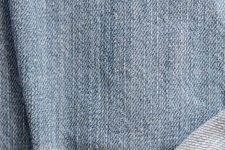 Old blue jeans texture close-up. Denim background. Top viewの写真素材
