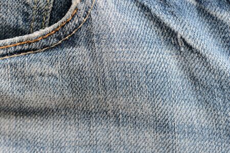 Old blue jeans texture close-up. Denim background. Top viewの写真素材