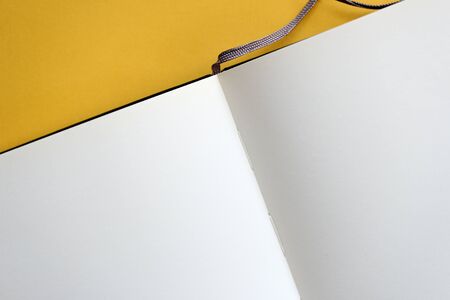 Top view of open blank notebook on yellow background close-up. The concept of education, business, planning. Flat layの写真素材