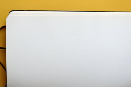 Top view of open blank notebook on yellow background close-up. The concept of education, business, planning. Flat layの写真素材