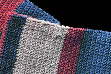 Crochet texture close-up of blue, red and beige threads, top view. Hand made concept. Abstract...