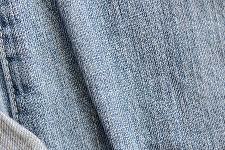 Old torn blue jeans texture close up, top view. Denim backgroundの写真素材