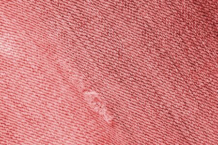 Old jeans texture close up, top view. Denim background, red color tonedの写真素材