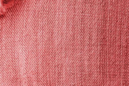 Old jeans texture close up, top view. Denim background, red color tonedの写真素材