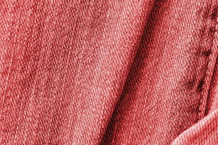 Old jeans texture close up, top view. Denim background, red color tonedの写真素材