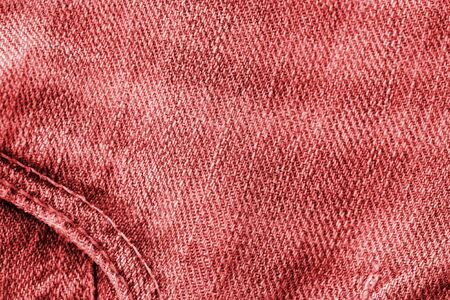 Old jeans texture close up, top view. Denim background, red color tonedの写真素材