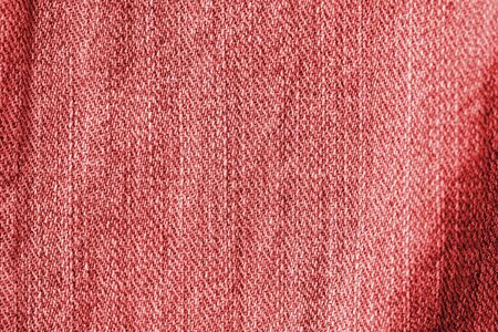 Old jeans texture close up, top view. Denim background, red color tonedの写真素材