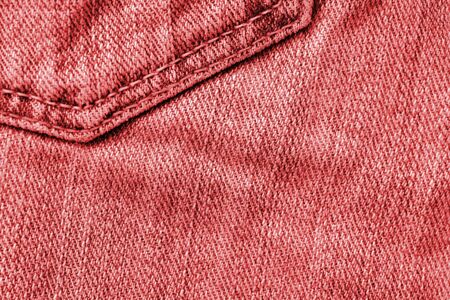 Old jeans texture close up, top view. Denim background, red color tonedの写真素材