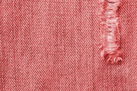Old jeans texture close up, top view. Denim background, red color tonedの写真素材