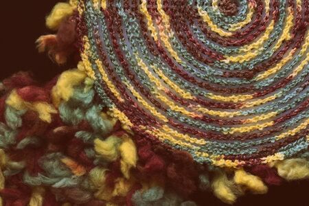 Fluffy multi-colored yarn crocheted on a round plastic canvas close-up. Two parts for the handmade bag. Retro style toned. Top viewの写真素材