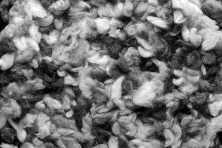 Fragment of a crocheted circle from melange threads based on a plastic canvas close-up. Black and whiteの写真素材
