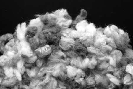 Fragment of a crocheted circle from melange threads based on a plastic canvas close-up. Black and whiteの写真素材