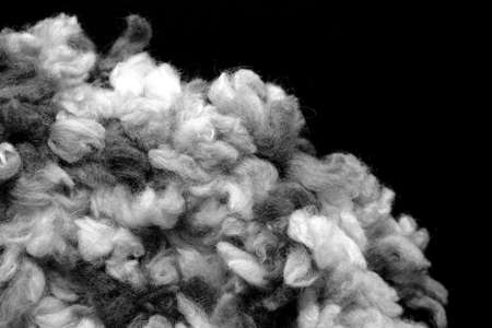 Fragment of a crocheted circle from melange threads based on a plastic canvas close-up. Black and whiteの写真素材
