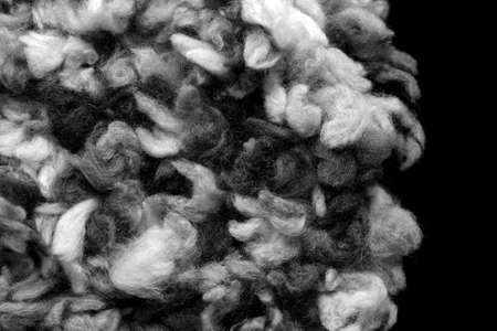 Fragment of a crocheted circle from melange threads based on a plastic canvas close-up. Black and whiteの写真素材
