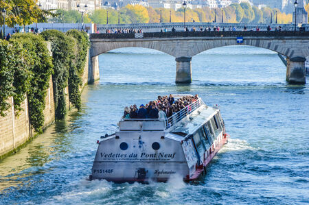 River of Paris with a boat and a bridgeのeditorial素材