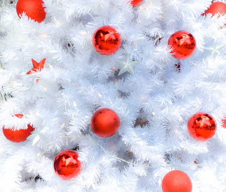 Snow white christmas tree with decoration in redの写真素材